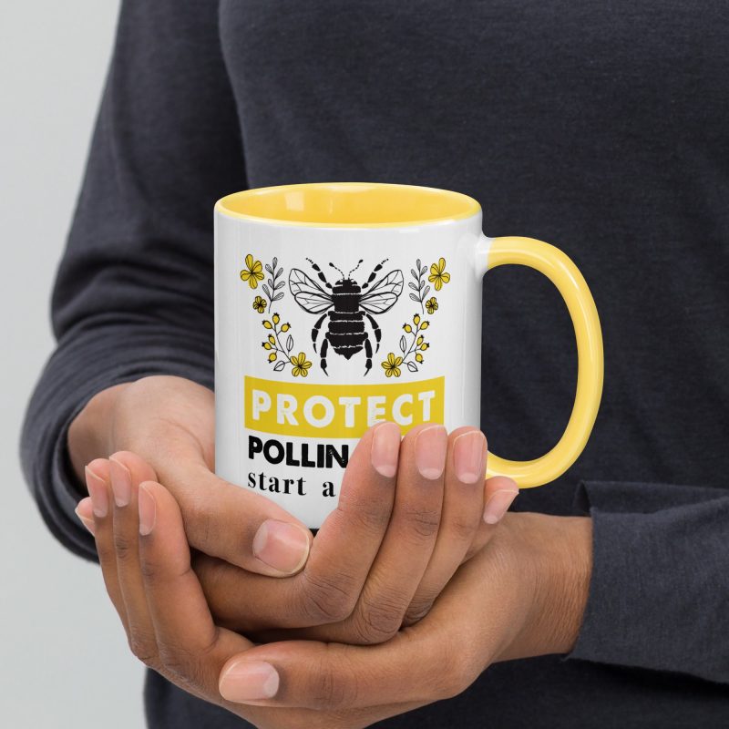 Protect Pollinators white ceramic mug with color inside yellow 11oz front with model